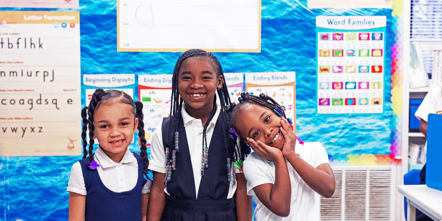Students smiling in a classroom